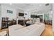 Open-concept living room with hardwood floors, a fireplace, and a view of the modern kitchen at 635 Holcomb Bridge Rd, Norcross, GA 30071
