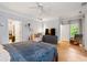 Spacious main bedroom featuring hardwood floors, crown molding, and backyard views at 635 Holcomb Bridge Rd, Norcross, GA 30071