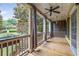 Inviting front porch with decorative columns and a beautiful view of the landscaped front yard at 635 Holcomb Bridge Rd, Norcross, GA 30071