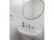 Elegant powder room features a pedestal sink with an oval mirror and modern fixtures at 635 Holcomb Bridge Rd, Norcross, GA 30071