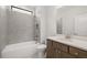Bathroom with gray tile, white cabinets, brushed nickel fixtures, plus a tub/shower combo at 1649 Tielman Way, Snellville, GA 30078