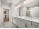 Elegant bathroom with double vanity, granite counters and views through to the adjoining bedroom at 1649 Tielman Way, Snellville, GA 30078