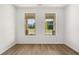 Bright bedroom with two large windows overlooking yard; wood-look floors and white trim at 1649 Tielman Way, Snellville, GA 30078