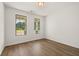Bedroom with two windows showing mature trees, and beautiful wood-look flooring at 1649 Tielman Way, Snellville, GA 30078