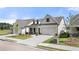 Attractive single-Gathering home featuring a concrete driveway, lush lawn, and stone-accented front porch columns at 1649 Tielman Way, Snellville, GA 30078