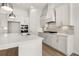 Bright, modern kitchen with white cabinets, stainless steel appliances, and large island at 1649 Tielman Way, Snellville, GA 30078