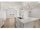 Bright kitchen showcasing a large center island, hardwood floors, and stainless steel appliances at 1649 Tielman Way, Snellville, GA 30078