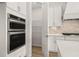 Modern kitchen features stainless steel appliances, including double ovens, and a walk-in pantry at 1649 Tielman Way, Snellville, GA 30078