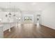 Open concept living space with hardwood floors, white walls, and ample natural light from large windows at 1649 Tielman Way, Snellville, GA 30078