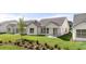 Rear exterior view of homes with lush lawns, covered patio, and mature trees in community at 1649 Tielman Way, Snellville, GA 30078