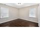 Bedroom with hardwood floors, neutral walls, and ample natural light at 1856 Austell Sw Cir, Marietta, GA 30060
