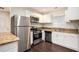 Bright kitchen with stainless steel appliances, light cabinets, and granite countertops at 1856 Austell Sw Cir, Marietta, GA 30060