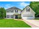 Inviting two-story home with a well-manicured lawn and attached two car garage at 3227 Ivy Lake Ct, Buford, GA 30519