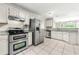 Bright kitchen with stainless appliances, white cabinets, and granite countertops at 3227 Ivy Lake Ct, Buford, GA 30519