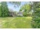 Beautiful backyard featuring a screened-in porch, a detached garage, and lush landscaping at 3404 Orchard St, Hapeville, GA 30354