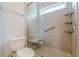 A bathroom with a glass shower, tiled walls, and a toilet at 3404 Orchard St, Hapeville, GA 30354