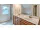 Bathroom featuring dual sinks, tub, and a shower with glass door at 3404 Orchard St, Hapeville, GA 30354