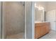 Bathroom showcases a glass shower and vanity with storage and a double sink at 3404 Orchard St, Hapeville, GA 30354