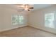 Spacious bedroom with carpet flooring, two windows and a ceiling fan at 3404 Orchard St, Hapeville, GA 30354