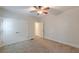 A bedroom with neutral walls and carpet flooring, as well as a ceiling fan at 3404 Orchard St, Hapeville, GA 30354