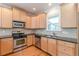 Contemporary kitchen with stainless steel appliances, wood cabinets, and tile backsplash at 3404 Orchard St, Hapeville, GA 30354