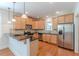 Modern kitchen featuring wood cabinets, stainless steel appliances, and black countertops at 3404 Orchard St, Hapeville, GA 30354