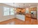 Bright eat-in kitchen featuring stainless steel appliances, wood cabinets, and hardwood floors at 3404 Orchard St, Hapeville, GA 30354