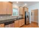 Charming kitchen featuring stainless steel appliances, wood cabinets, and modern fixtures at 3404 Orchard St, Hapeville, GA 30354