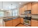 Stylish kitchen with modern appliances, wood cabinets, and an open layout at 3404 Orchard St, Hapeville, GA 30354