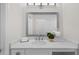 Bathroom featuring a sink with gray-trimmed mirror, white countertop, and decor at 433 The North Chace, Atlanta, GA 30328