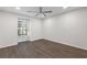 Bedroom featuring wood-look floors, ceiling fan, and a large window at 433 The North Chace, Atlanta, GA 30328