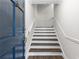 Welcoming entryway with hardwood stairs, blue door, and a view of the upper level at 433 The North Chace, Atlanta, GA 30328