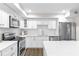 Bright kitchen featuring stainless steel appliances, white cabinets, and updated countertops at 433 The North Chace, Atlanta, GA 30328