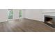Bright living room featuring hardwood floors, a classic fireplace, and ample natural light at 433 The North Chace, Atlanta, GA 30328