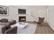 Stylish living room with hardwood floors, a cozy fireplace, and modern furnishings at 433 The North Chace, Atlanta, GA 30328