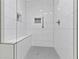 Modern bathroom shower with white tile surround and bench at 433 The North Chace, Atlanta, GA 30328