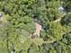 A high aerial view shows mature trees and a home hidden among them at 1042 Bailey Rd, Woodstock, GA 30188