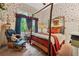 Cozy bedroom featuring a rustic four-poster bed and floral wallpaper at 1042 Bailey Rd, Woodstock, GA 30188