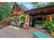 Inviting covered deck provides both seating and a hot tub, with an outdoor TV for entertainment at 1042 Bailey Rd, Woodstock, GA 30188