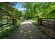 Long private driveway lined with lush landscaping leads to the estate, ensuring privacy and elegance at 1042 Bailey Rd, Woodstock, GA 30188