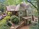 Two-story home featuring a wooden deck, covered patio, and lush landscaping at 1042 Bailey Rd, Woodstock, GA 30188