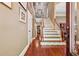 Elegant foyer with hardwood floors, staircase, and decorative trim at 1042 Bailey Rd, Woodstock, GA 30188