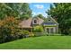 Beautiful single-Gathering home featuring a well-manicured lawn, mature trees, and cozy curb appeal at 1042 Bailey Rd, Woodstock, GA 30188