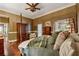 Comfortable main bedroom featuring a four-poster bed, neutral decor, and hardwood floors at 1042 Bailey Rd, Woodstock, GA 30188