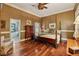 Traditional main bedroom with a four-poster bed, hardwood floors, and ensuite bathroom at 1042 Bailey Rd, Woodstock, GA 30188
