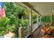 Relaxing porch with comfortable seating, fern hangings, and views of the surrounding greenery at 1042 Bailey Rd, Woodstock, GA 30188