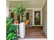 Cozy front porch with rocking chairs, hanging ferns, and charming wood door at 1042 Bailey Rd, Woodstock, GA 30188