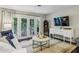 Comfortable living room with outdoor view with a white sofa and elegant decor at 3650 Ashford Dunwoody Ne Rd # 1024, Atlanta, GA 30319