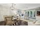 Inviting living room and dining area features stylish light fixture, white sofa, and access to a private balcony at 3650 Ashford Dunwoody Ne Rd # 1024, Atlanta, GA 30319