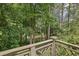 Beautiful wooded view from the home's deck overlooking the lush greenery and serene water at 3650 Ashford Dunwoody Ne Rd # 1024, Atlanta, GA 30319